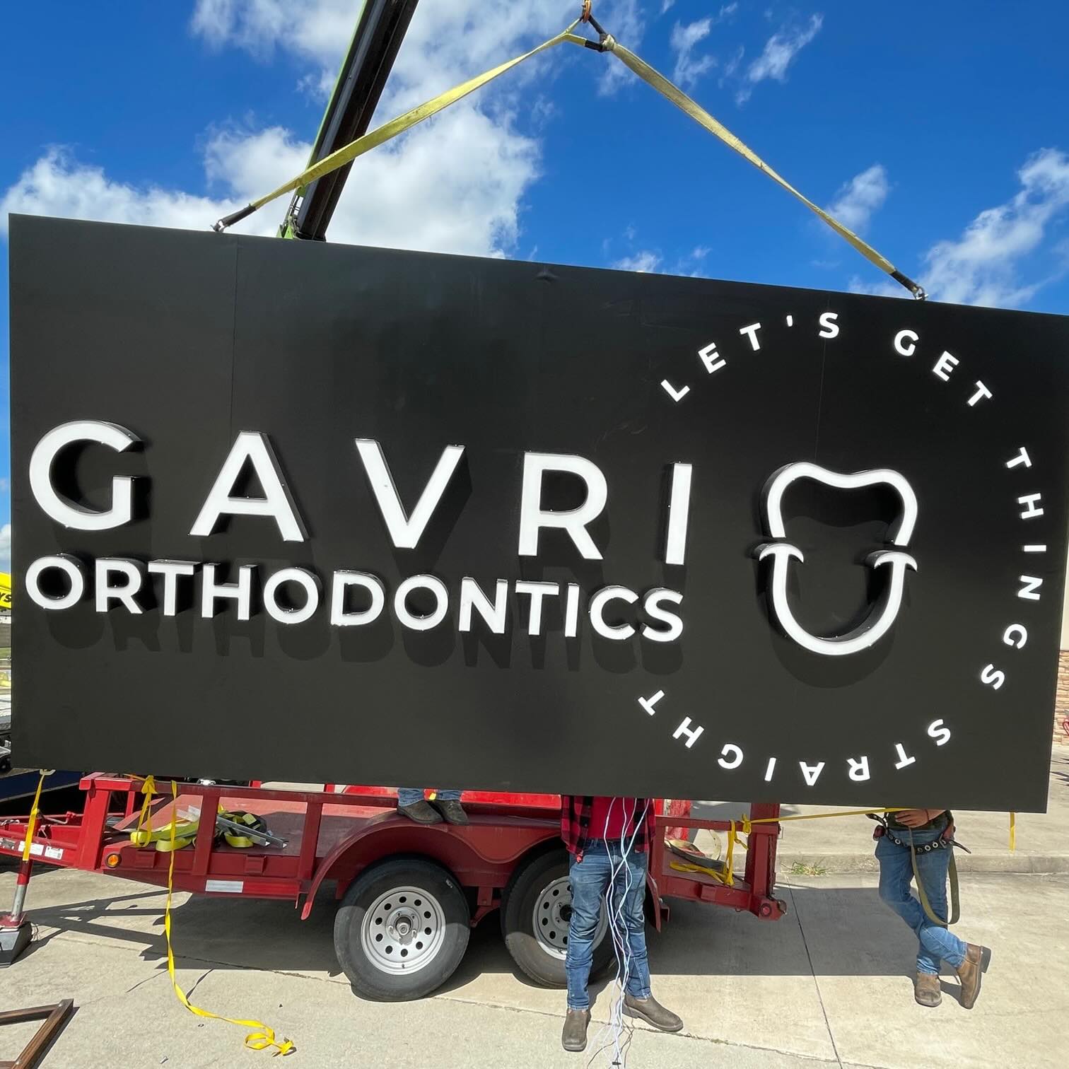 New Gavri Orthodontics sign installation against blue sky, Richmond orthodontic office update